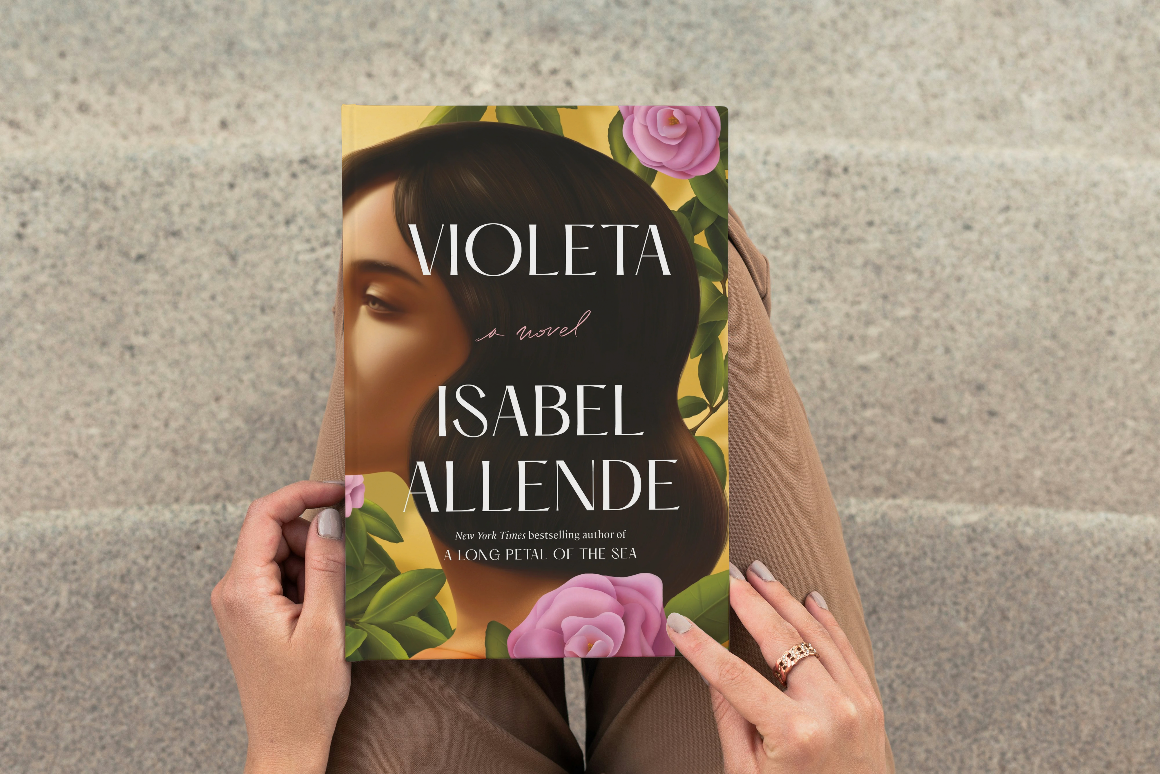 an image of a woman holding the book violeta by isabel allende