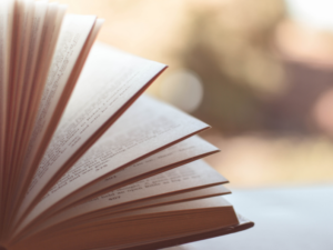 photo of book with pages being flipped through tips to get out of a reading slump