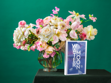 photo of book water moon by samanatha sotto yambao beside a vase of flowers