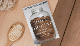 book holy ground by catherine coleman flowers sitting on a dresser with a brush and hair tie