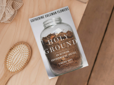 book holy ground by catherine coleman flowers sitting on a dresser with a brush and hair tie