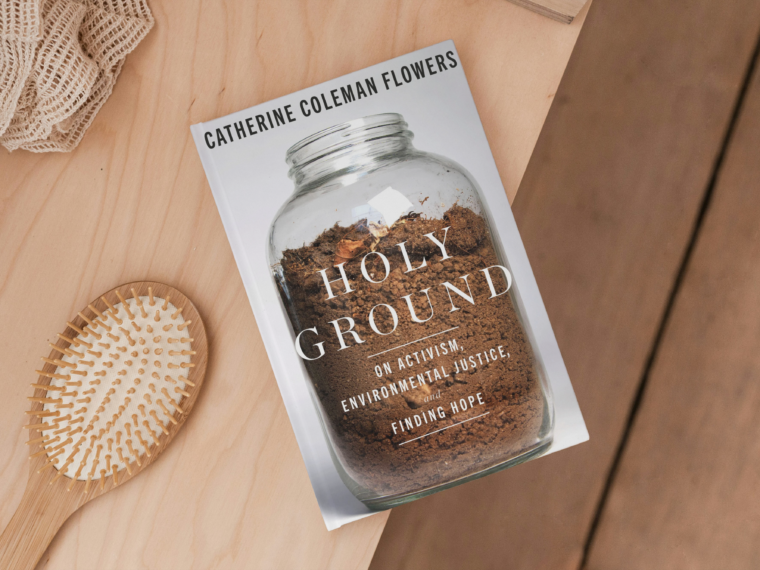 book holy ground by catherine coleman flowers sitting on a dresser with a brush and hair tie