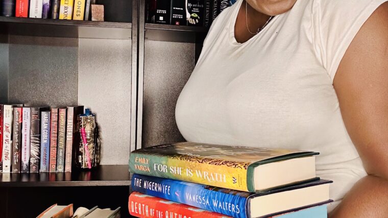 kathleen Haagenson holding a stack of books from 2025 april tbr