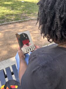 kathleen haagenson holding a copy of the buffalo hunter hunter by stephen graham jones