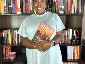 kathleen haagenson holding the book junie while posing in front of bookshelves for juneteenth vibes