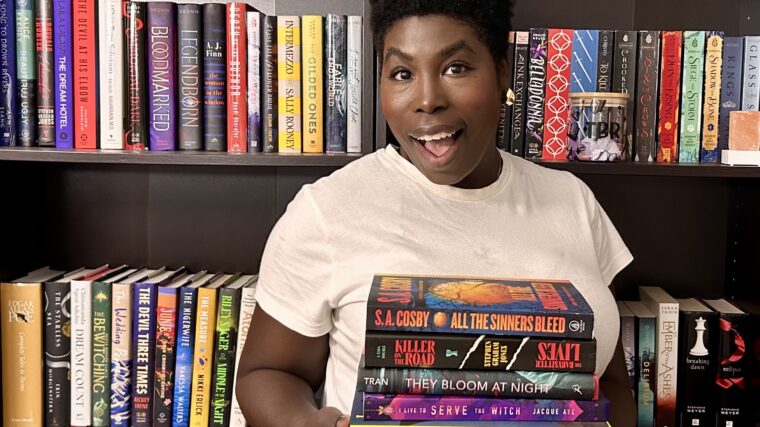 fall reading and self care photo of Kathleen Haagenson holding a stack of fall themed books