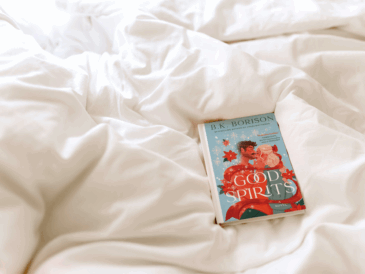 the book good spirits by b.k. borison laying on a comforter of a bed